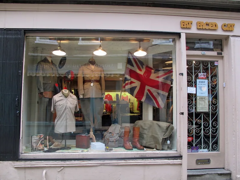 A vintage clothing shop window in Camden Passage, with mannequins, boots and a Union Jack