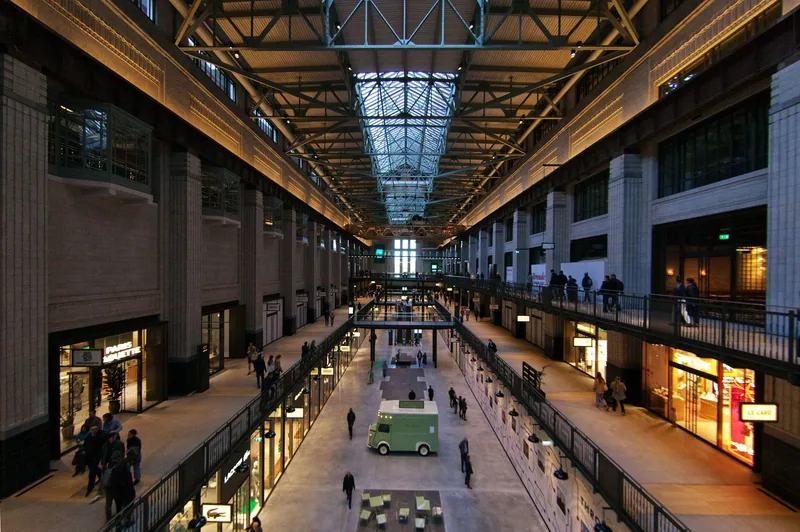 The glazed turbine hall inside Battersea Power Station, lined with shops on two levels