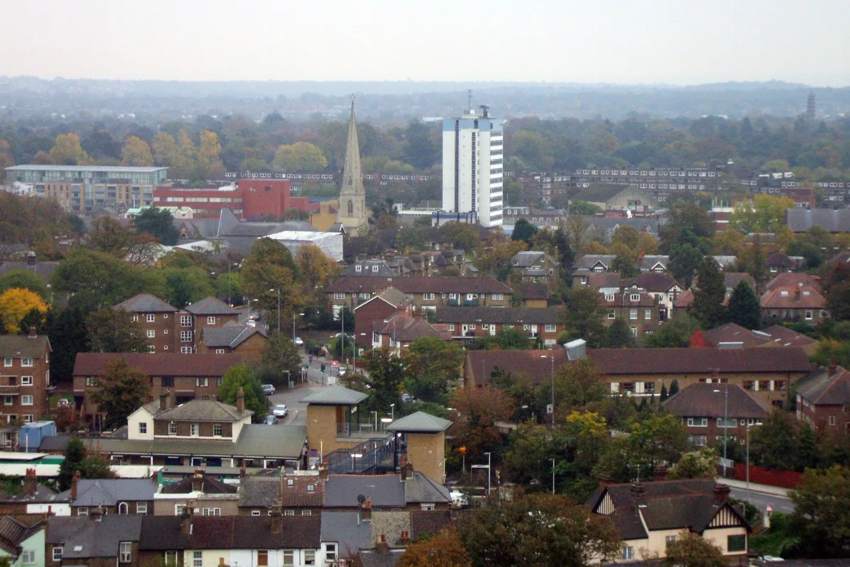 Brentford rooftops seen from above, with a church spire and a white tower block