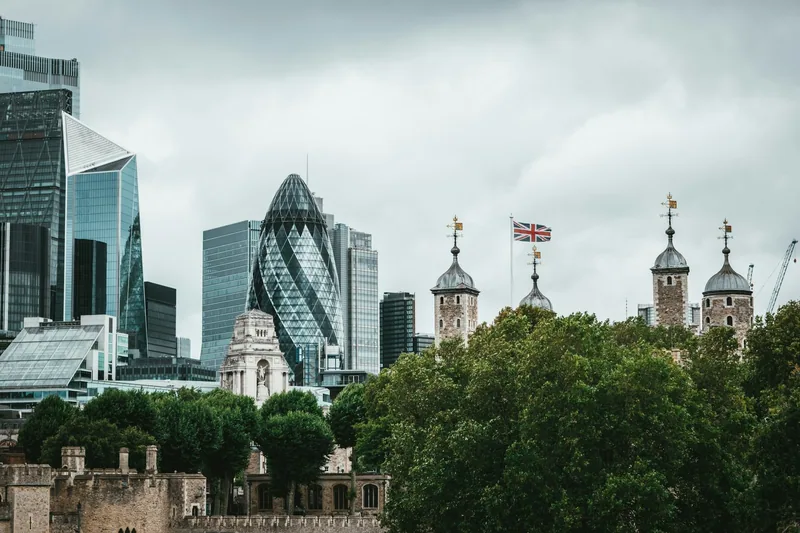 The Gherkin and neighbouring office towers rising behind the turrets of the Tower of London
