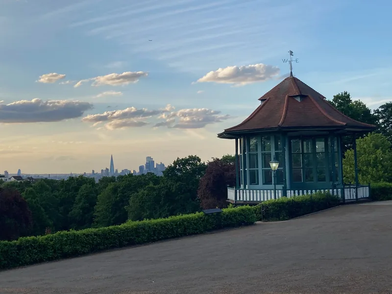 The bandstand in the Horniman Gardens, with the London skyline on the horizon beyond