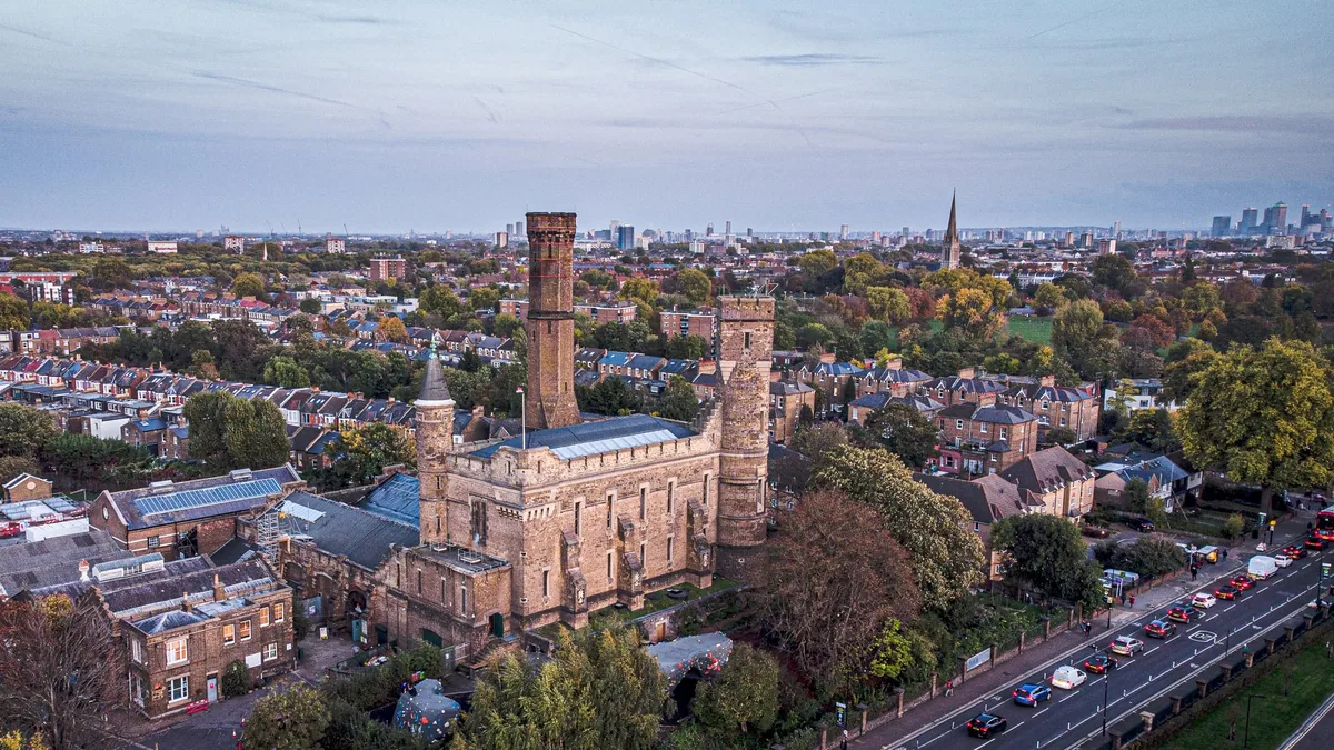 Aerial view over Stoke Newington with the castellated Castle Climbing Centre and the city skyline