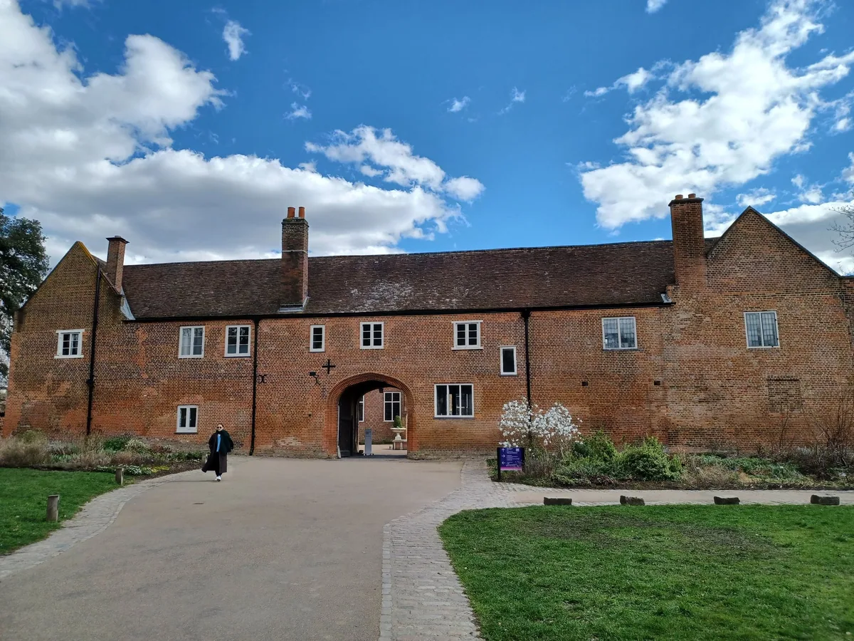 The Tudor red-brick west front of Fulham Palace with its arched gateway and lawn