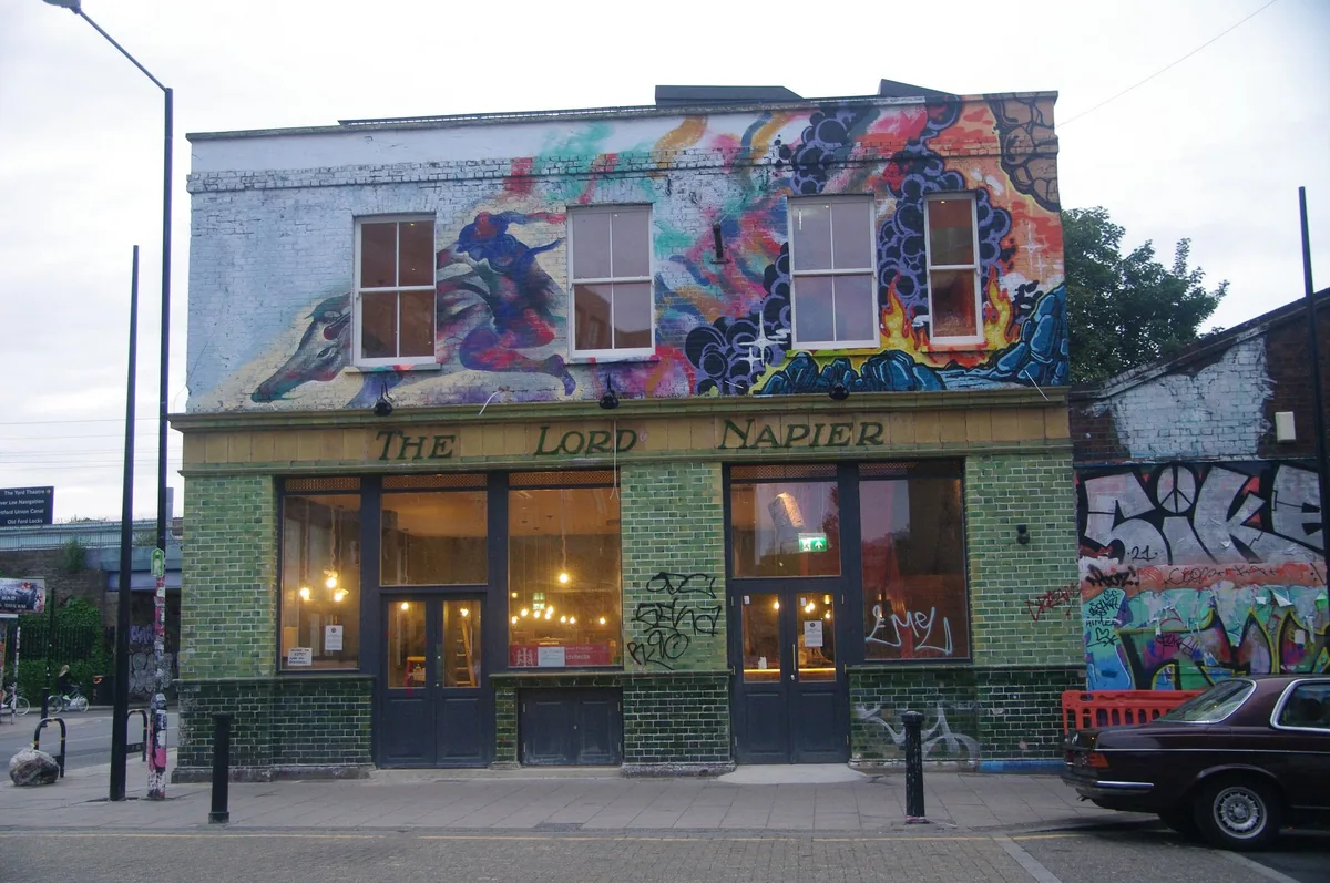 The Lord Napier pub on White Post Lane in Hackney Wick, its green-tiled front topped by a large painted mural