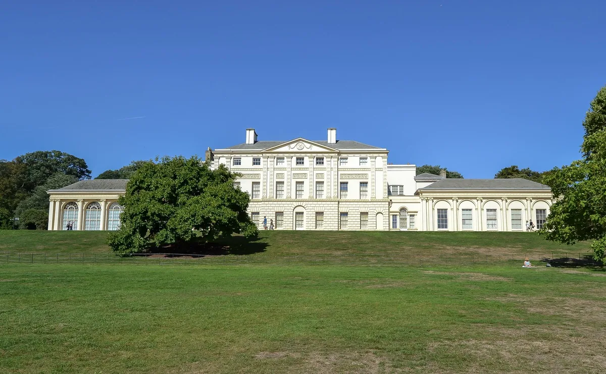 The white front of Kenwood House seen across its sloping lawn on Hampstead Heath