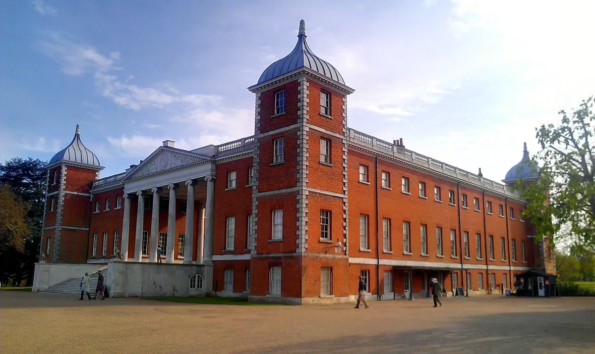 The red-brick mansion at Osterley Park with its corner turrets and the tall columned portico set between them