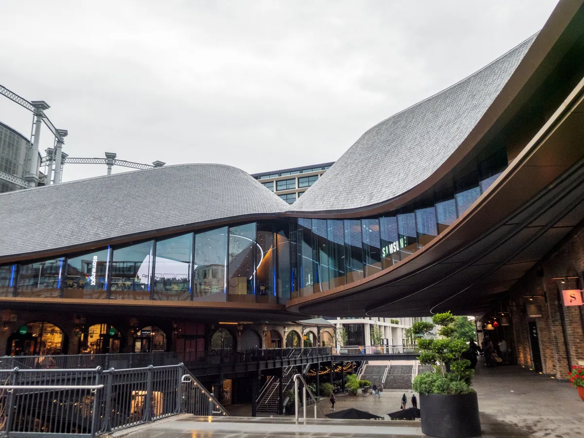 The curved overlapping roofs and brick arches of Coal Drops Yard in King's Cross