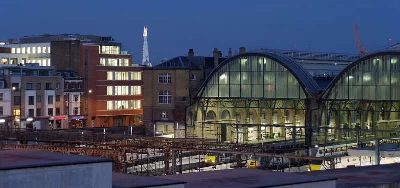 King's Cross railway station and its arched concourse roof lit up after dark
