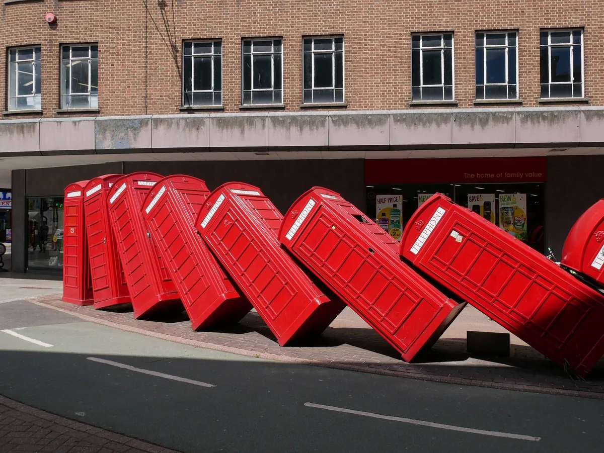 David Mach's Out of Order sculpture in Kingston, a row of red telephone boxes toppling against each other like dominoes