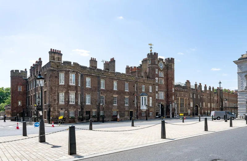 The brick ranges and turrets of St James's Palace seen across an empty forecourt