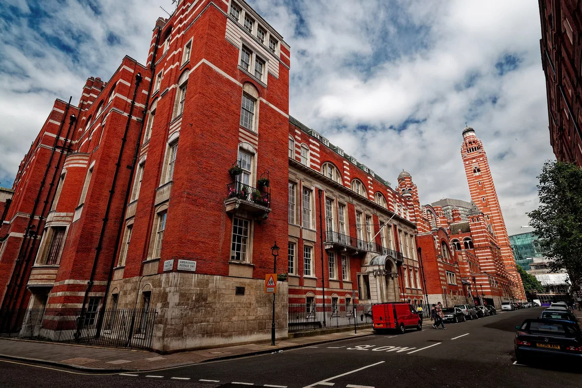 The striped red brick and stone walls of Westminster Cathedral and Archbishop's House, with the campanile rising behind