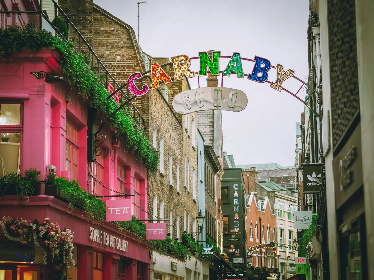 Colourful shopfronts and the Carnaby arch over a pedestrian street in Soho