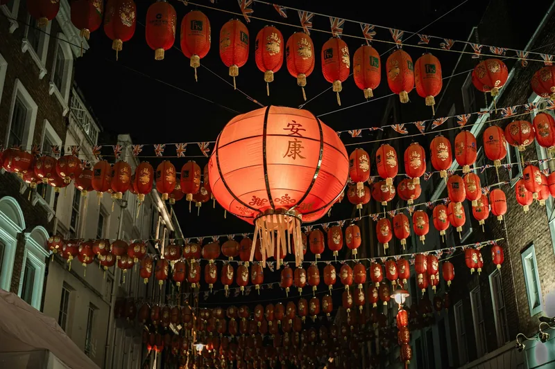 Rows of red Chinese lanterns strung above a street in Soho's Chinatown