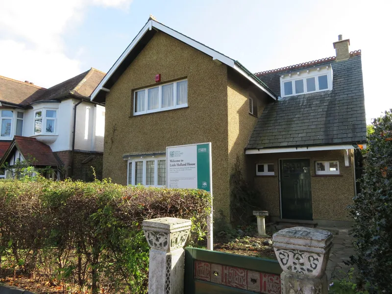 Little Holland House in Beeches Avenue, a roughcast Arts and Crafts house with a museum sign at its front hedge