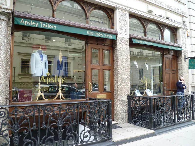 A bespoke tailor's shopfront on Pall Mall with suits on dummies in the window