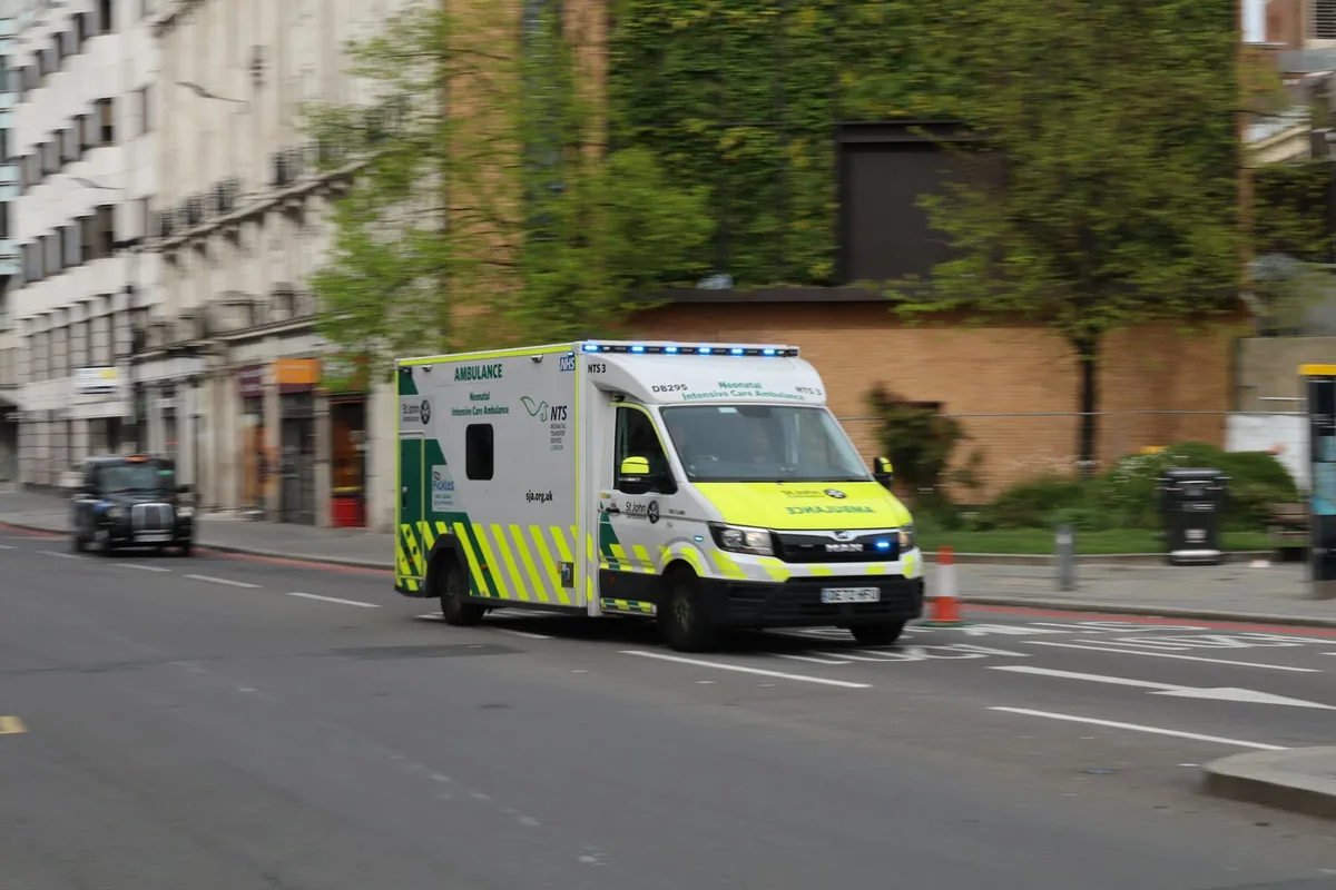 London Ambulance Service emergency ambulance driving along a city street
