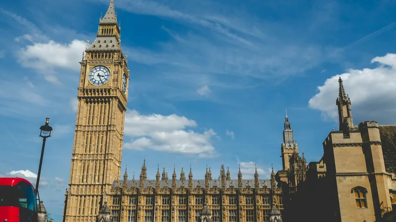 Big Ben and the Gothic towers of the Palace of Westminster against a blue sky