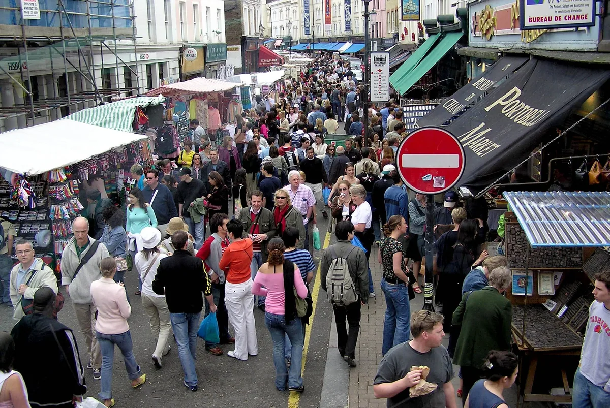 Crowds packed between the stalls and shopfronts of Portobello Road market in Notting Hill