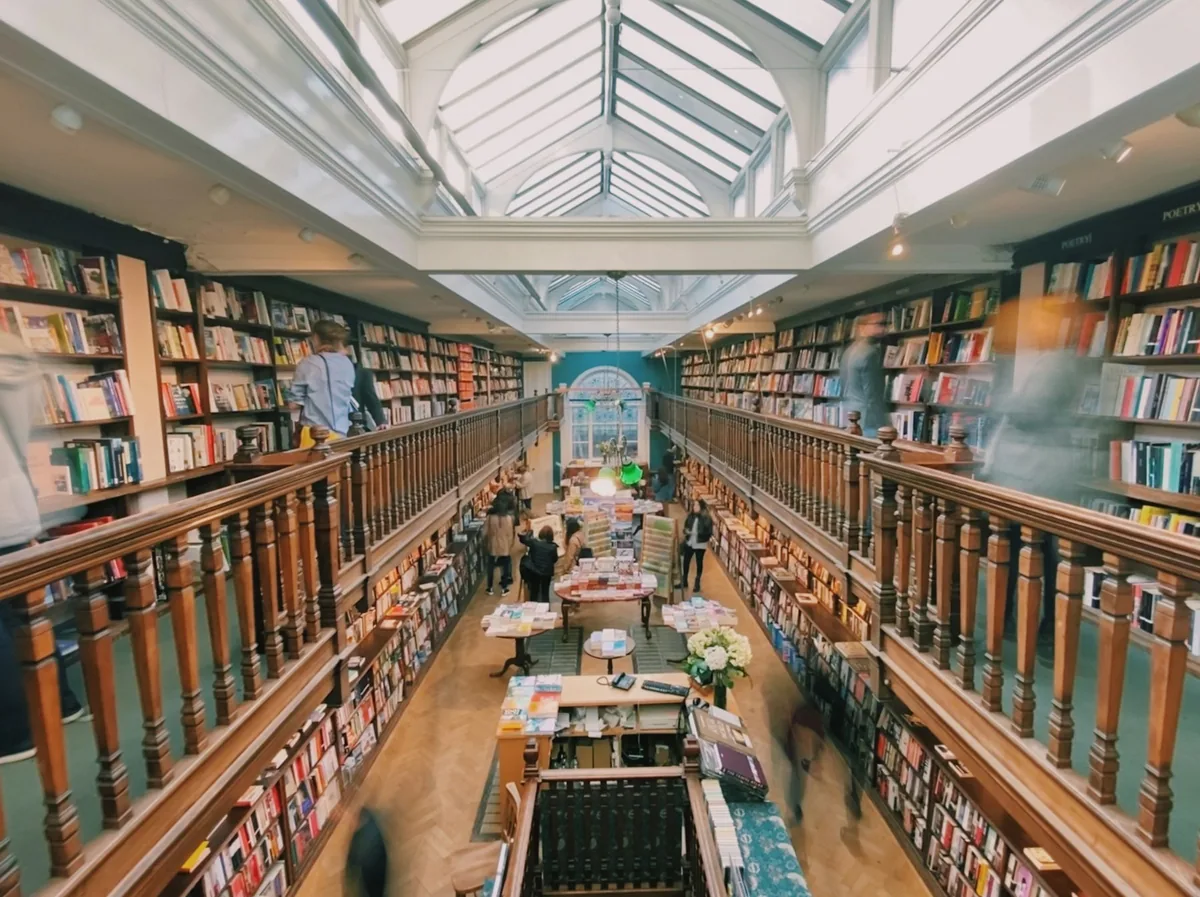 Galleried oak bookshop interior with long skylight and shelves running down both sides