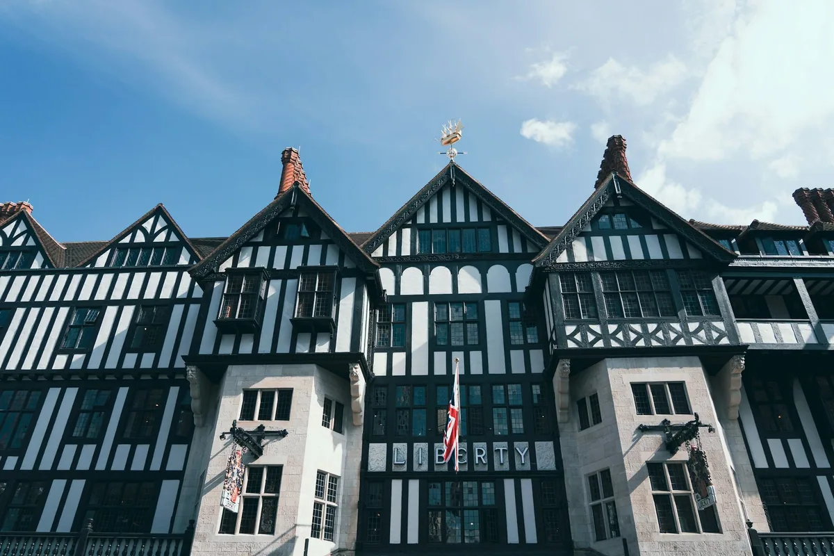 The mock-Tudor gables and timber framing of the Liberty department store beneath a blue sky