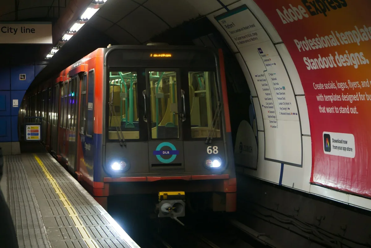 Red and blue Docklands Light Railway train arriving at the underground DLR platform at Bank station