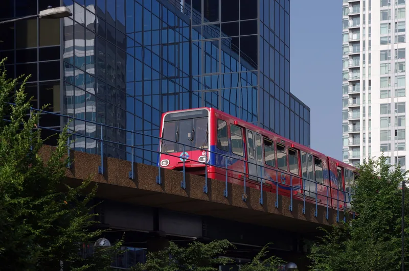 DLR train on an elevated viaduct heading south from South Quay among the Canary Wharf office towers