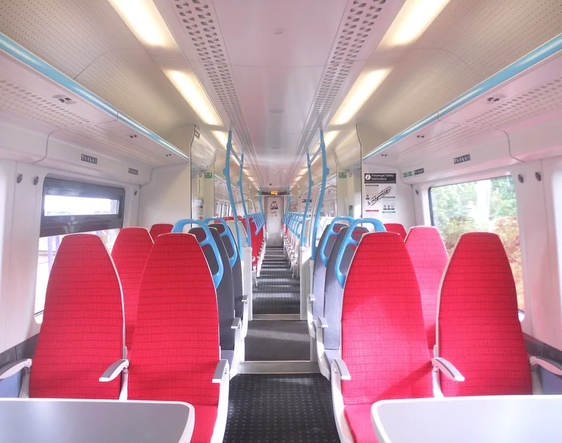 Standard class interior of a Gatwick Express train, with rows of empty red seats