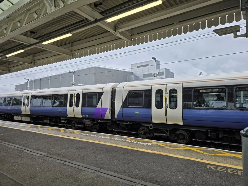 An Elizabeth line train at Romford station with its wide doorways level with the platform