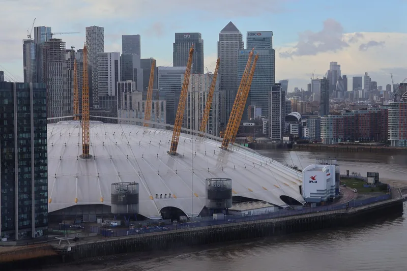 View from a cable car gondola over the Thames to the O2 dome and the Canary Wharf towers