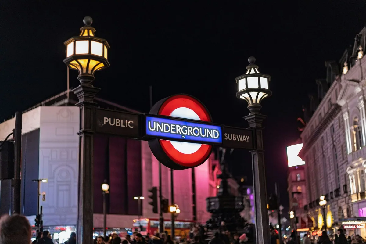 Illuminated Underground roundel at the Piccadilly Circus station entrance at night