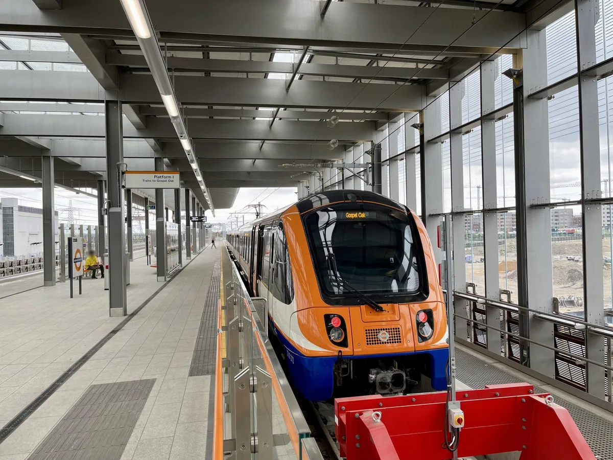 An orange and white Overground train standing at Barking Riverside with Gospel Oak shown on its destination display