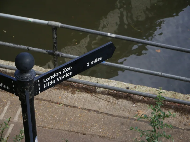 Black towpath fingerpost pointing to London Zoo and Little Venice, two miles along the canal