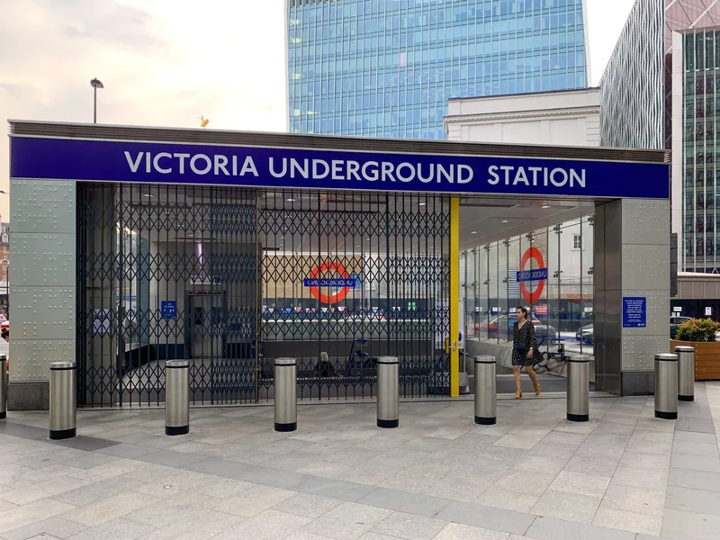 The street entrance to Victoria Underground station, with its blue name sign above the gates