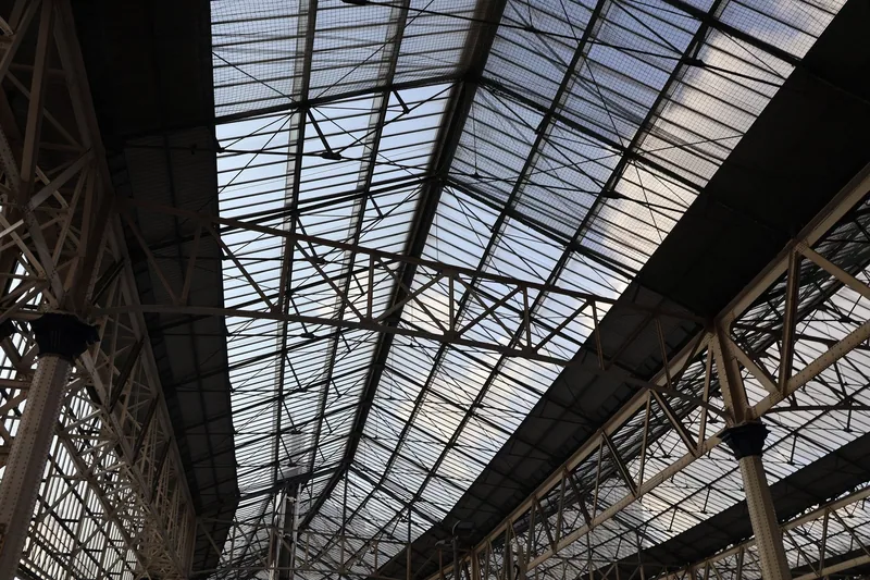 Iron trusses and glazed panels of the trainshed roof above the platforms at Waterloo