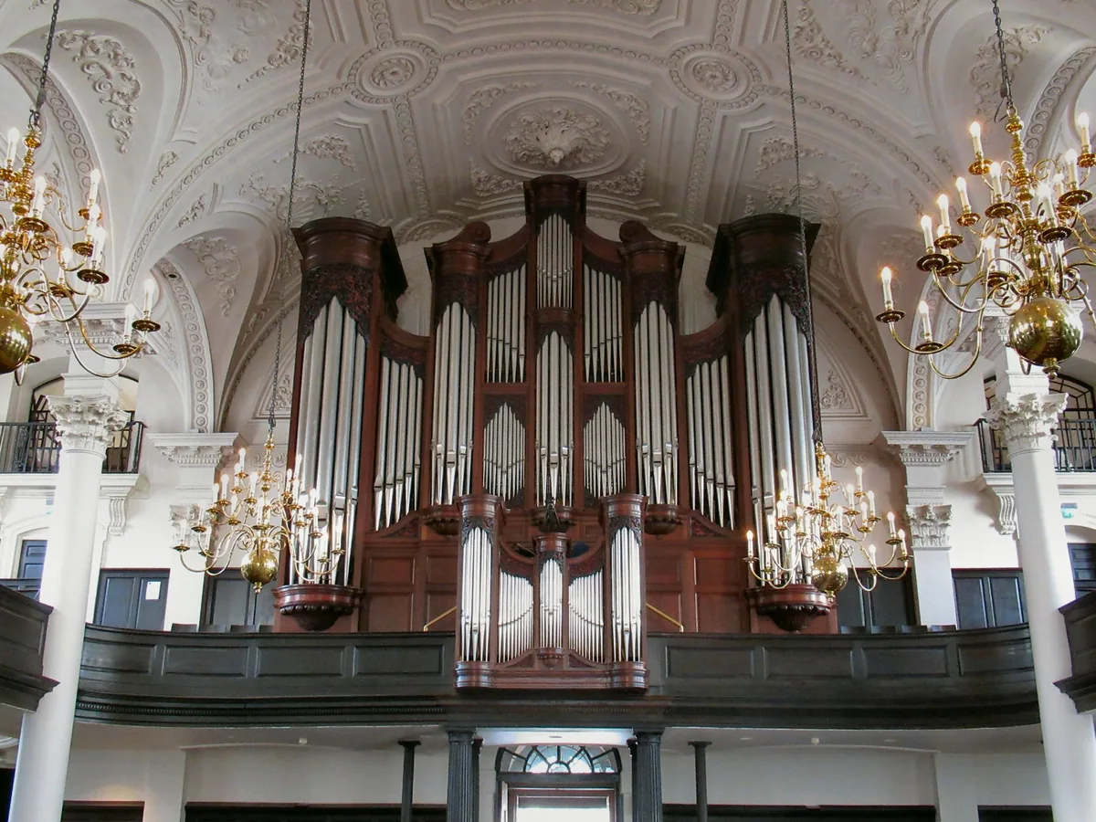 The organ case and brass chandeliers under the white plasterwork of St Martin-in-the-Fields