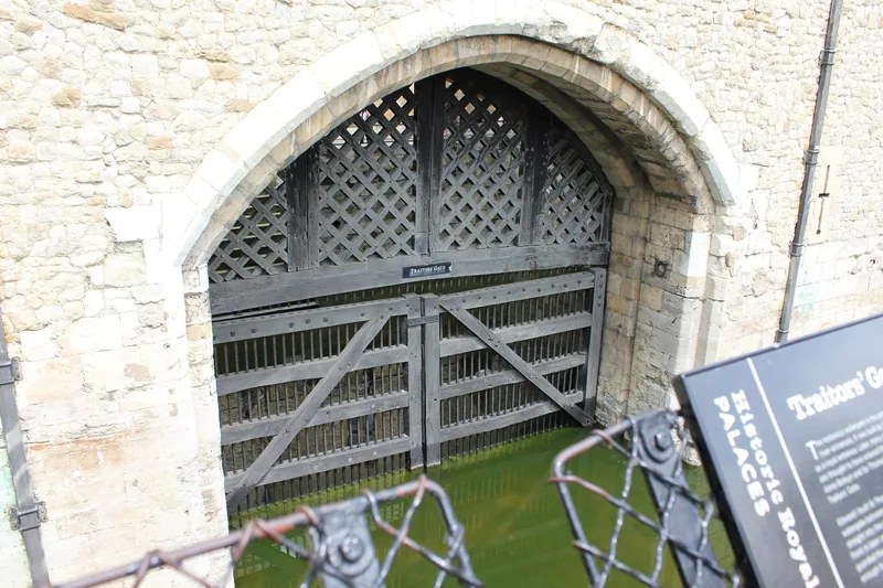 The heavy timber portcullis of Traitors' Gate above the water at the Tower of London