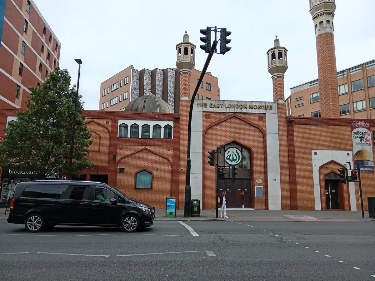 The East London Mosque in Whitechapel, red brick with minarets and an arched entrance
