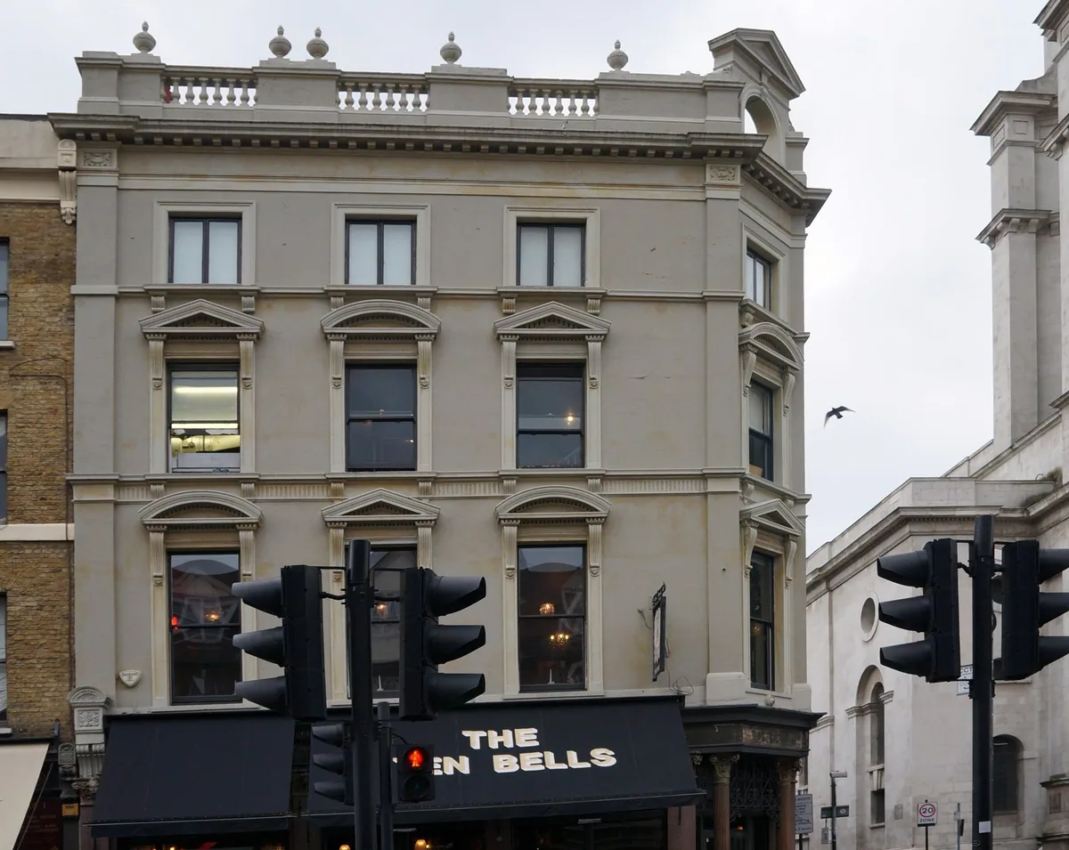 The Ten Bells pub in east London, its black name board below a pale rendered Victorian facade