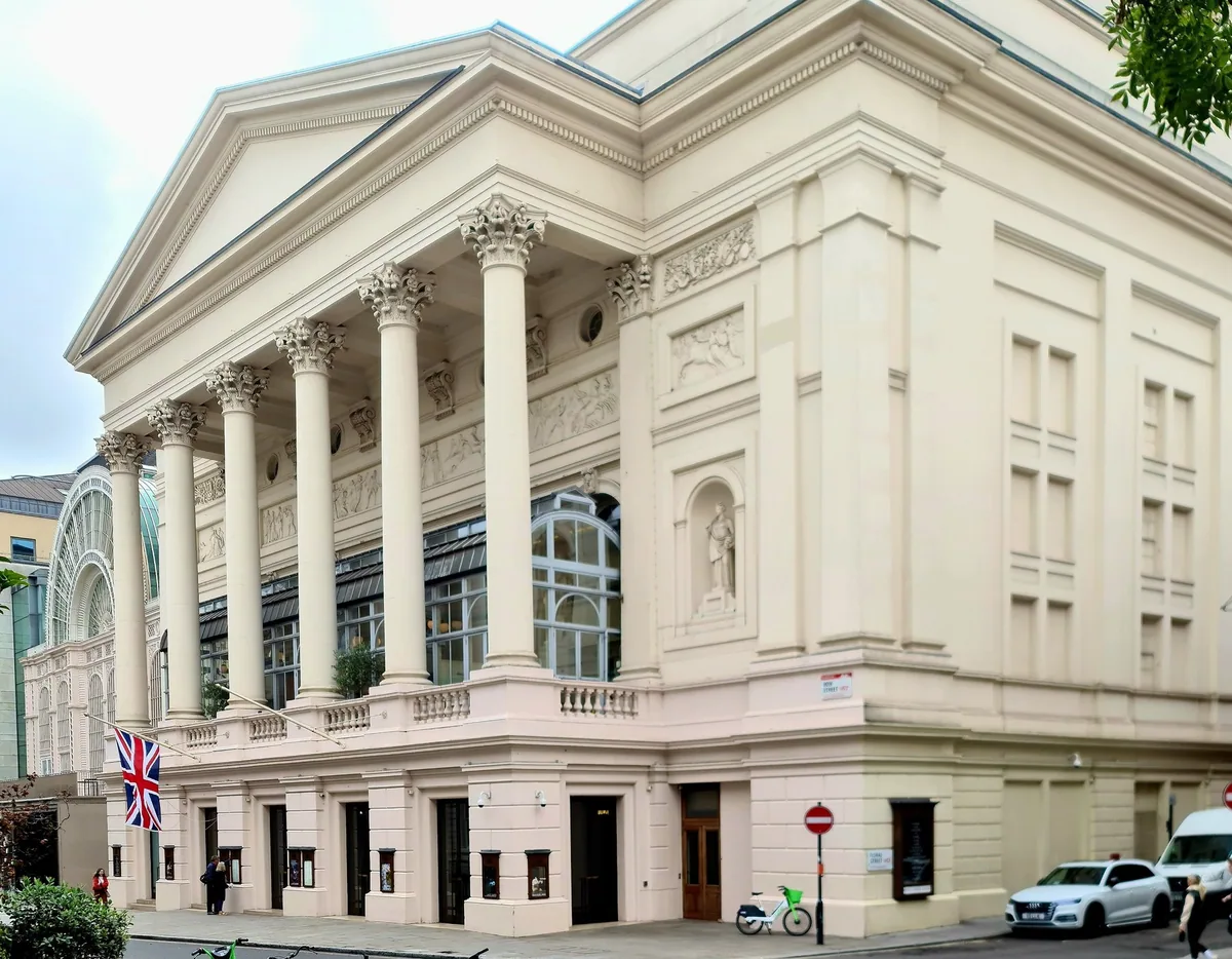 The Corinthian portico of the Royal Opera House on Bow Street, with a Union flag above the entrance