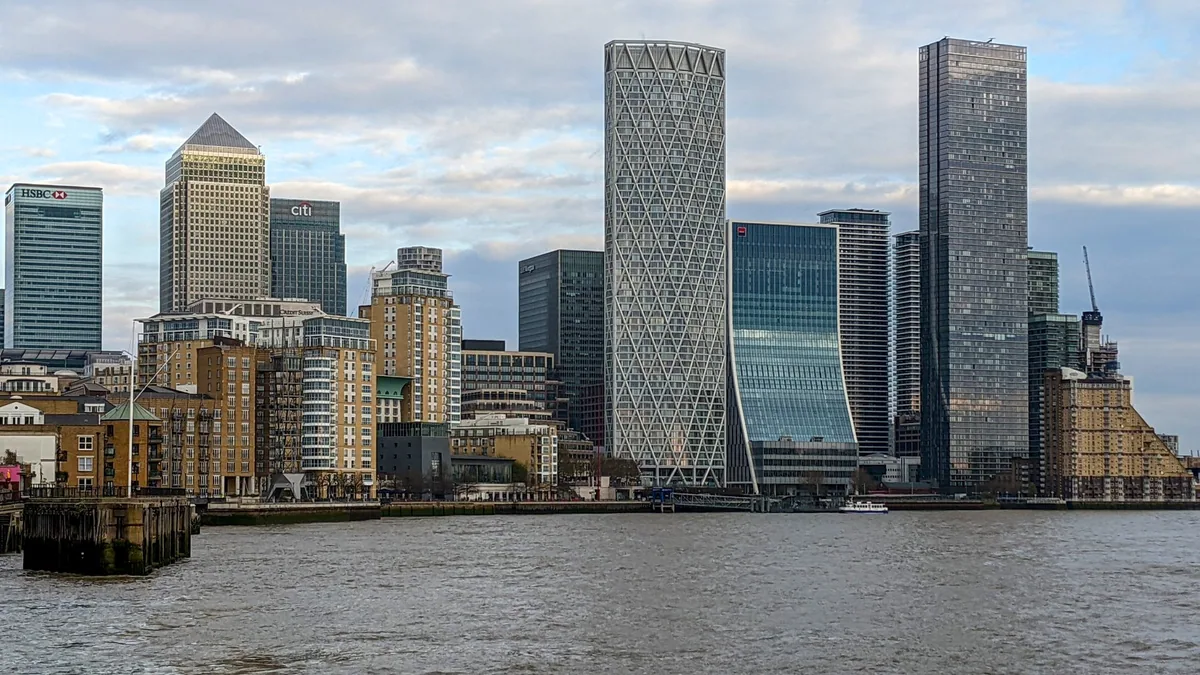 The Canary Wharf towers seen across the Thames from Limehouse on a cloudy afternoon