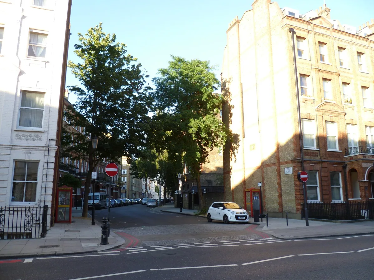 A leafy corner of Nevern Square in Earl's Court, lined with brick and stucco terraces
