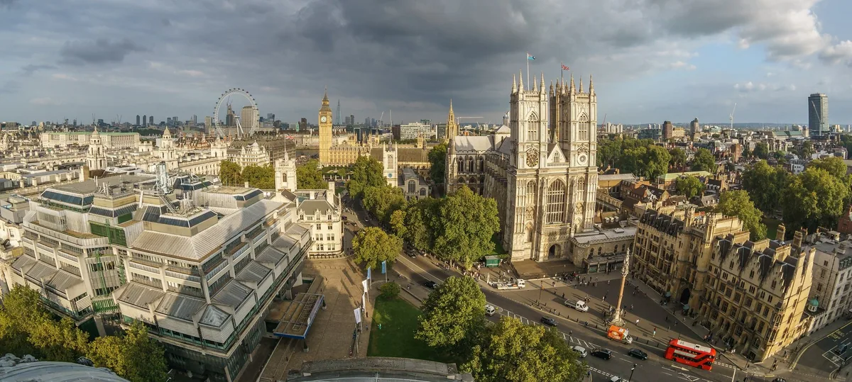 A rooftop view over Westminster with the Abbey, Big Ben and the London Eye beyond
